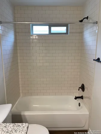 a bathroom with a bathtub and shower