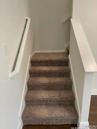 a view of staircase with white walls