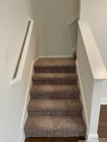 a view of staircase with white walls