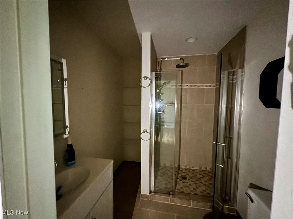 1425 Bennett Road Madison, OH 44057 - Photo 15 of 17 Bathroom with vanity, a shower with door, and tile patterned floors