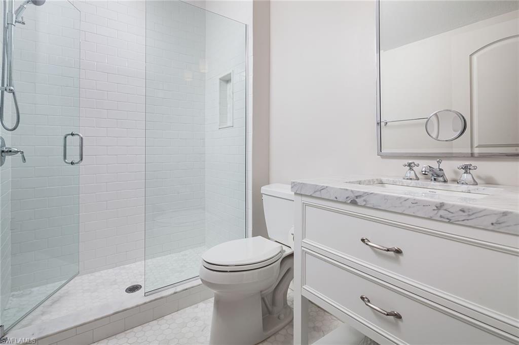 122 Caribbean Road Naples, FL 34108 - Photo 18 of 31 a bathroom with a sink a toilet and shower