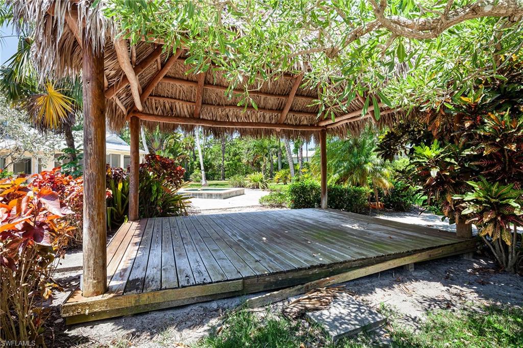 122 Caribbean Road Naples, FL 34108 - Photo 19 of 31 a view of a backyard with a tree