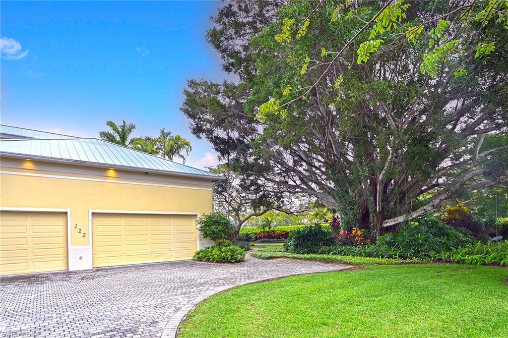 122 Caribbean Road Naples, FL 34108 - Photo 27 of 31 a view of a house with a backyard