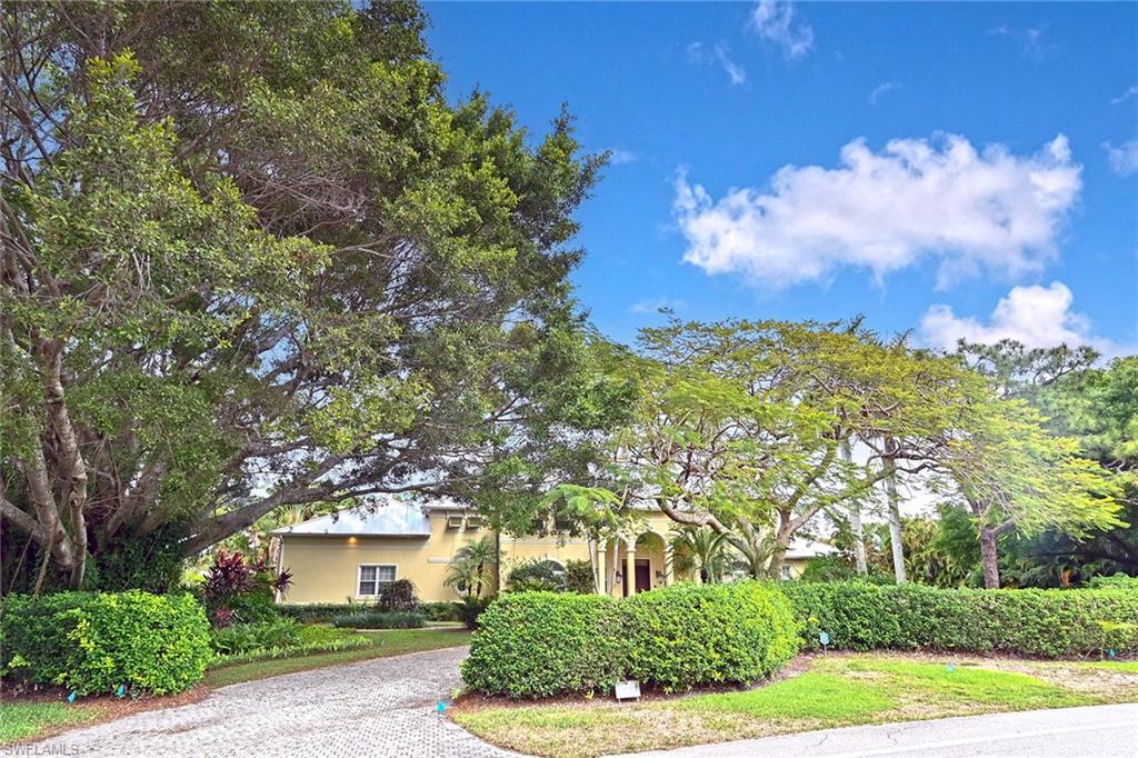 122 Caribbean Road Naples, FL 34108 - Photo 28 of 31 a front view of a house with garden