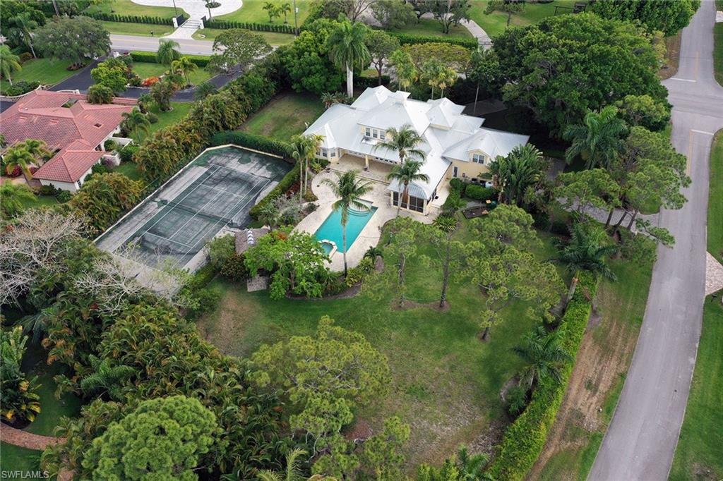 122 Caribbean Road Naples, FL 34108 - Photo 29 of 31 an aerial view of a house with a yard and lake
