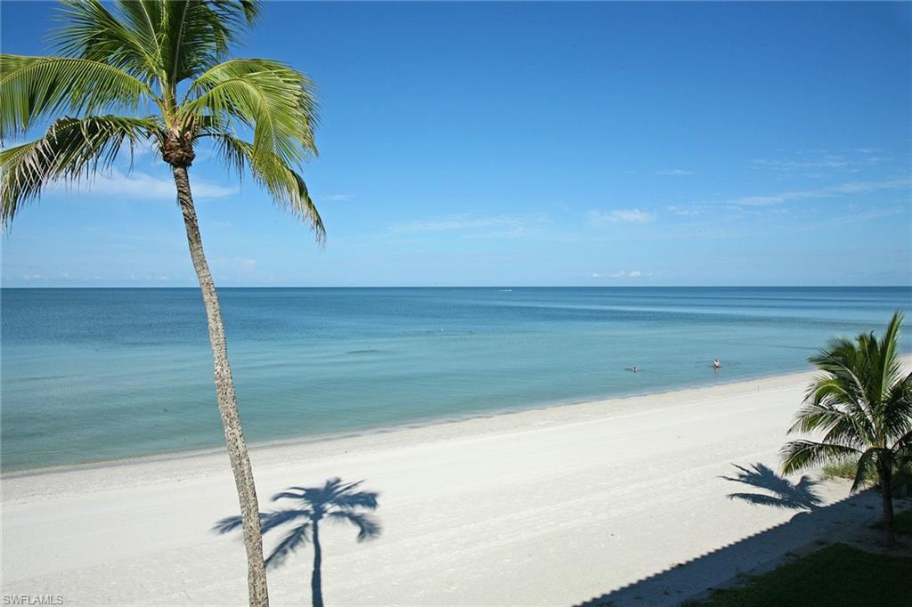 122 Caribbean Road Naples, FL 34108 - Photo 30 of 31 a vase of flowers sitting on a floor in a room