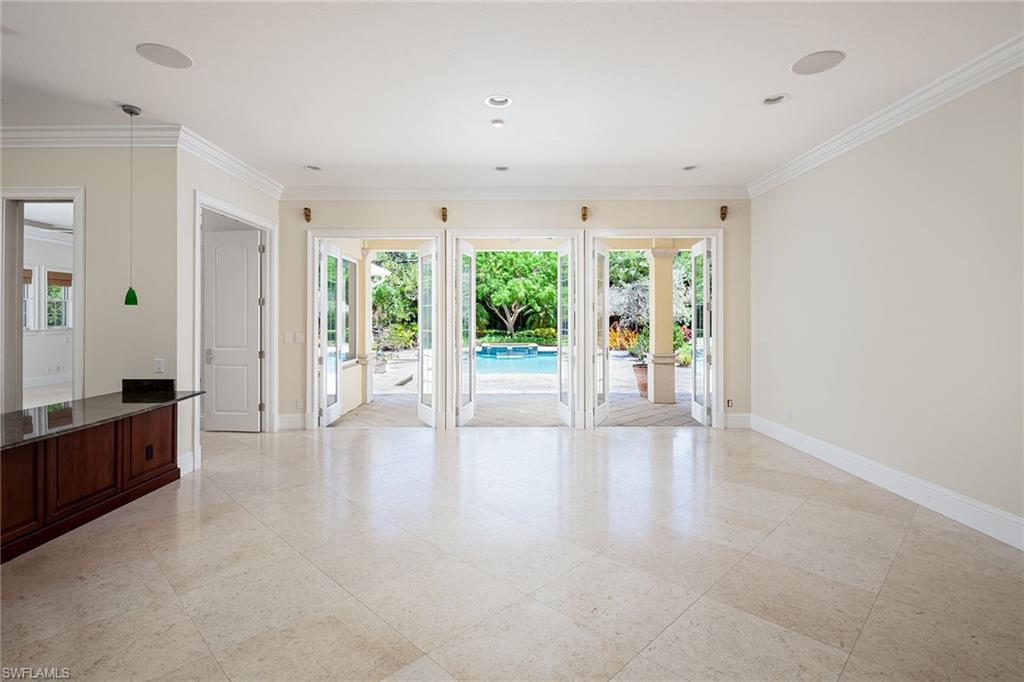 122 Caribbean Road Naples, FL 34108 - Photo 3 of 31 wooden floor in an empty room with a sliding door