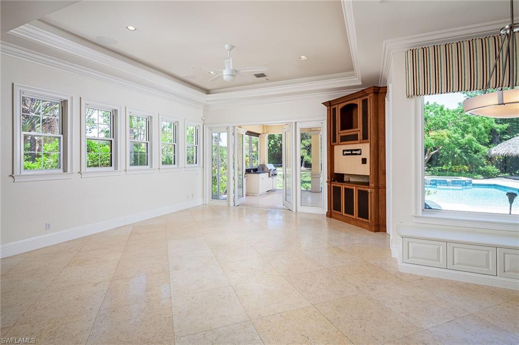122 Caribbean Road Naples, FL 34108 - Photo 4 of 31 a view of an empty room with a window