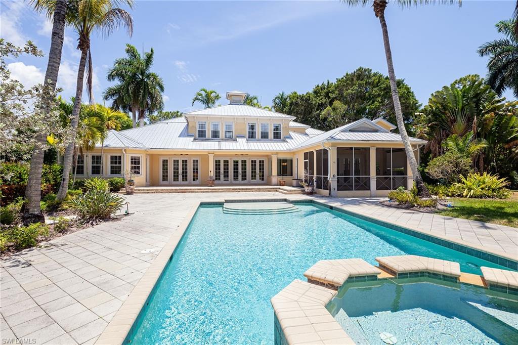 122 Caribbean Road Naples, FL 34108 - Photo 8 of 31 a front view of a house with garden