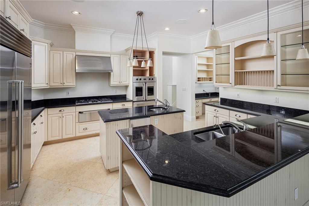 122 Caribbean Road Naples, FL 34108 - Photo 9 of 31 a kitchen with stainless steel appliances granite countertop a sink a stove and a refrigerator