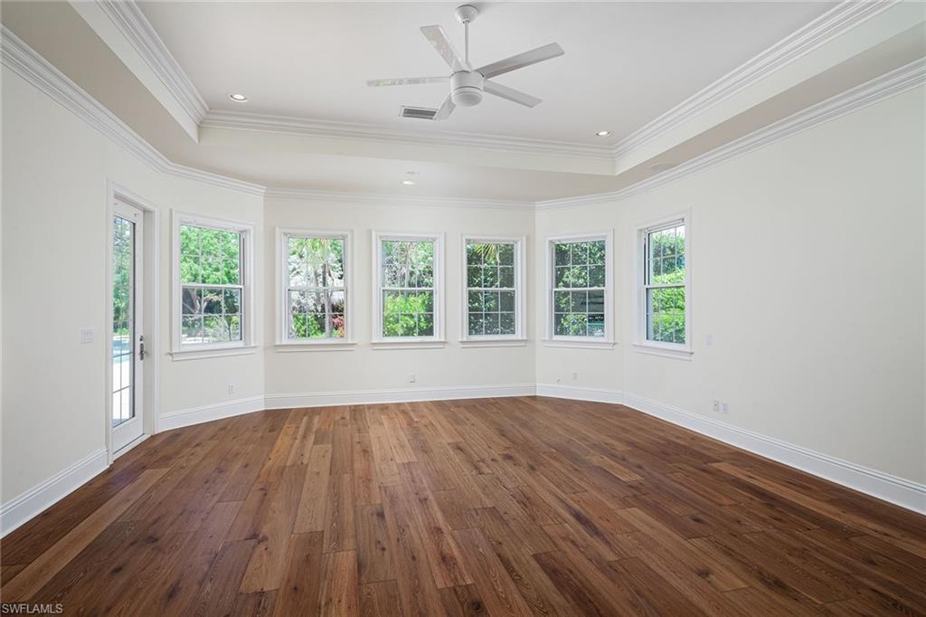 122 Caribbean Road Naples, FL 34108 - Photo 10 of 31 wooden floor in an empty room with a window