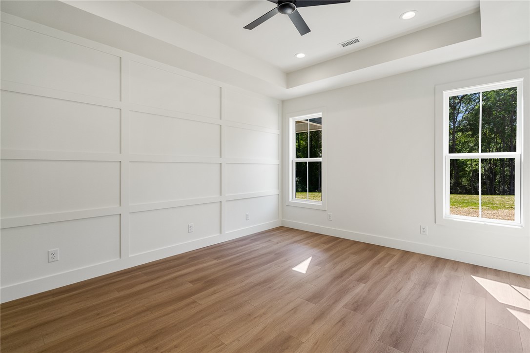 2125 A Honea Path Park Road Anderson, SC 29625 - Photo 12 of 26 This spacious room features elegant wall paneling, rich wood flooring, and ample natural light.