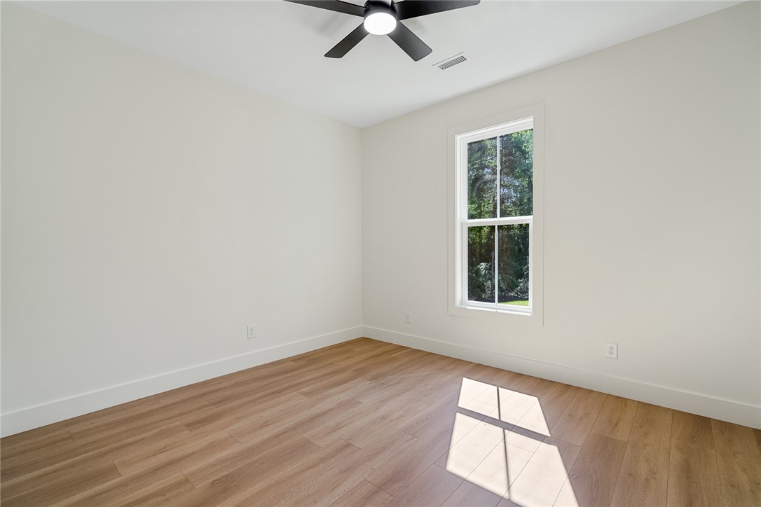 2125 A Honea Path Park Road Anderson, SC 29625 - Photo 17 of 26 This spacious room features ample natural light and durable flooring, offering a comfortable living space.