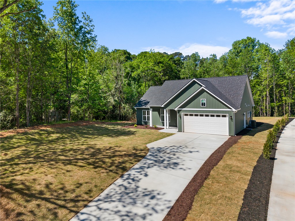 2125 A Honea Path Park Road Anderson, SC 29625 - Photo 2 of 26 This charming residence offers a welcoming facade with a convenient attached garage.