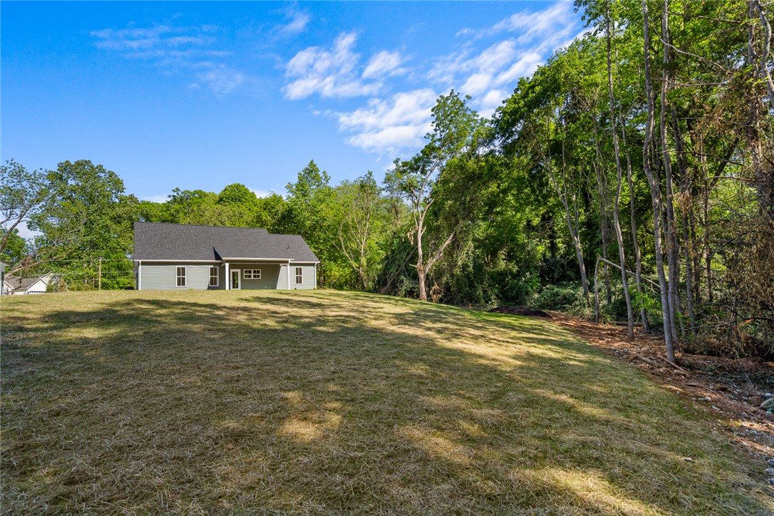 2125 A Honea Path Park Road Anderson, SC 29625 - Photo 22 of 26 This tranquil property offers a serene retreat with expansive outdoor space surrounded by lush trees.