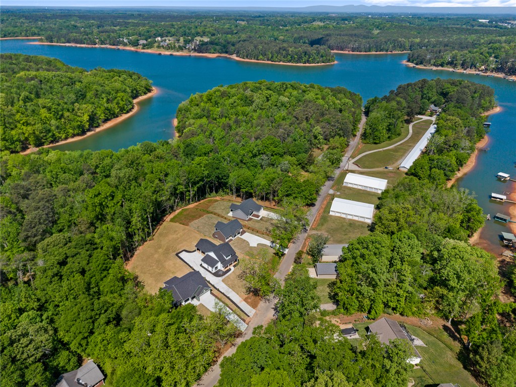 2125 A Honea Path Park Road Anderson, SC 29625 - Photo 25 of 26 Perched above serene waters, this property offers a captivating lake view amidst lush green surroundings.