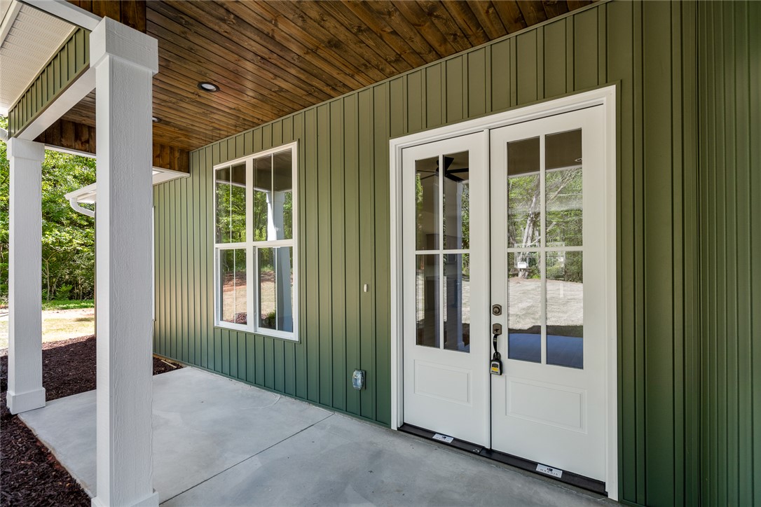 2125 A Honea Path Park Road Anderson, SC 29625 - Photo 4 of 26 This inviting outdoor space features a charming porch and sturdy white pillars, perfect for enjoying peaceful moments.