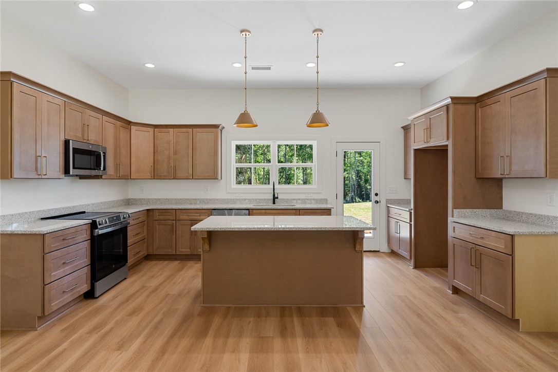 2125 A Honea Path Park Road Anderson, SC 29625 - Photo 9 of 26 This spacious culinary haven features ample cabinetry and a functional island, perfect for gathering.