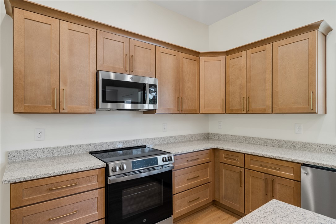 2125 A Honea Path Park Road Anderson, SC 29625 - Photo 10 of 26 This modern kitchen features warm wooden cabinetry, sleek stainless steel appliances, and elegant granite countertops.