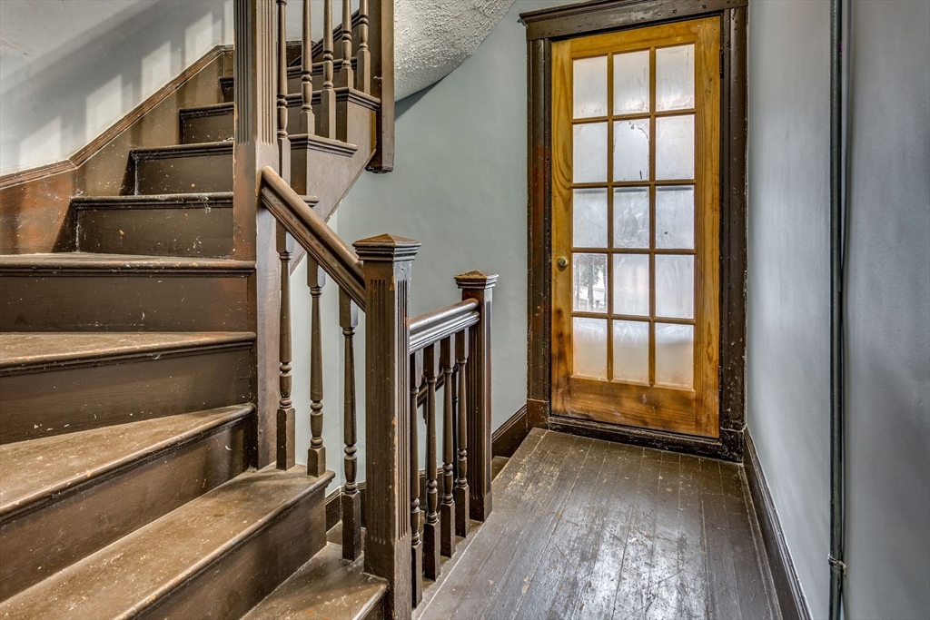 10 Winter Street, Unit 3 Boston, MA 02110 - Photo 2 of 7 a view of staircase with lots of frames on wall and a window