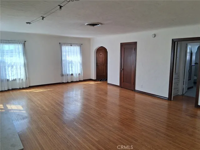 a view of a room with wooden floor and window