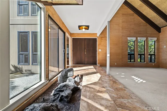 a living room with a couch a fireplace and a large window