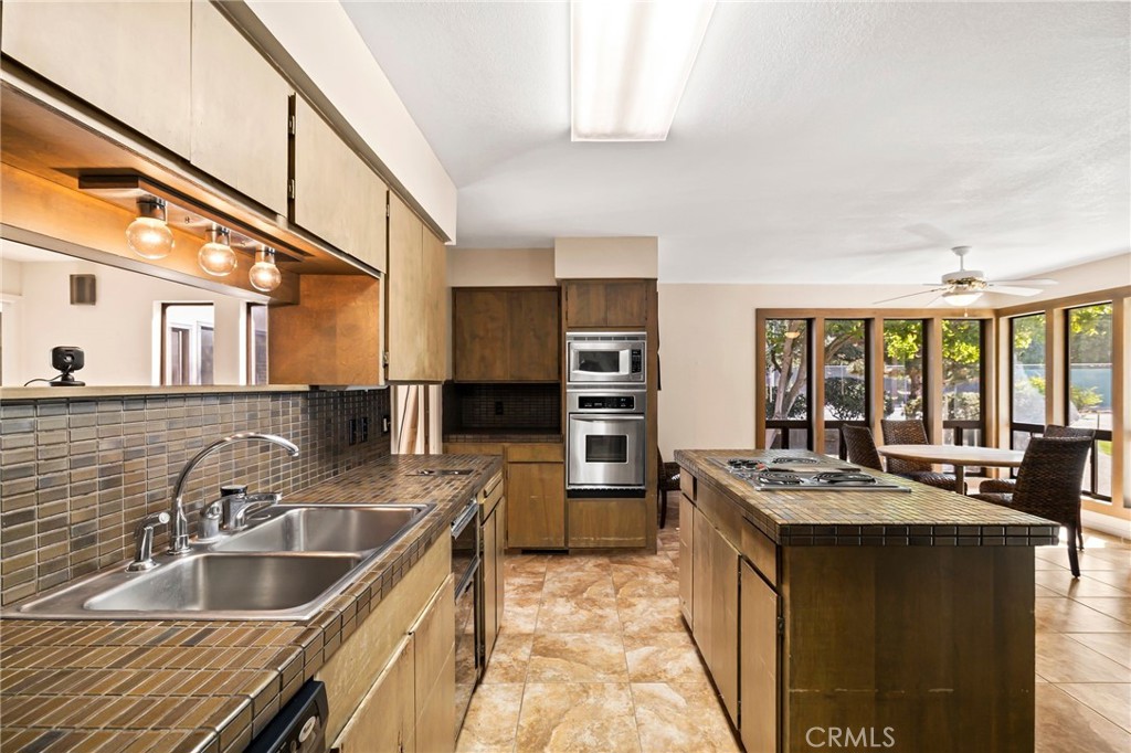 6357 County Road 48 Willows, CA 95988 - Photo 20 of 75 a kitchen with stainless steel appliances granite countertop a sink stove and cabinets