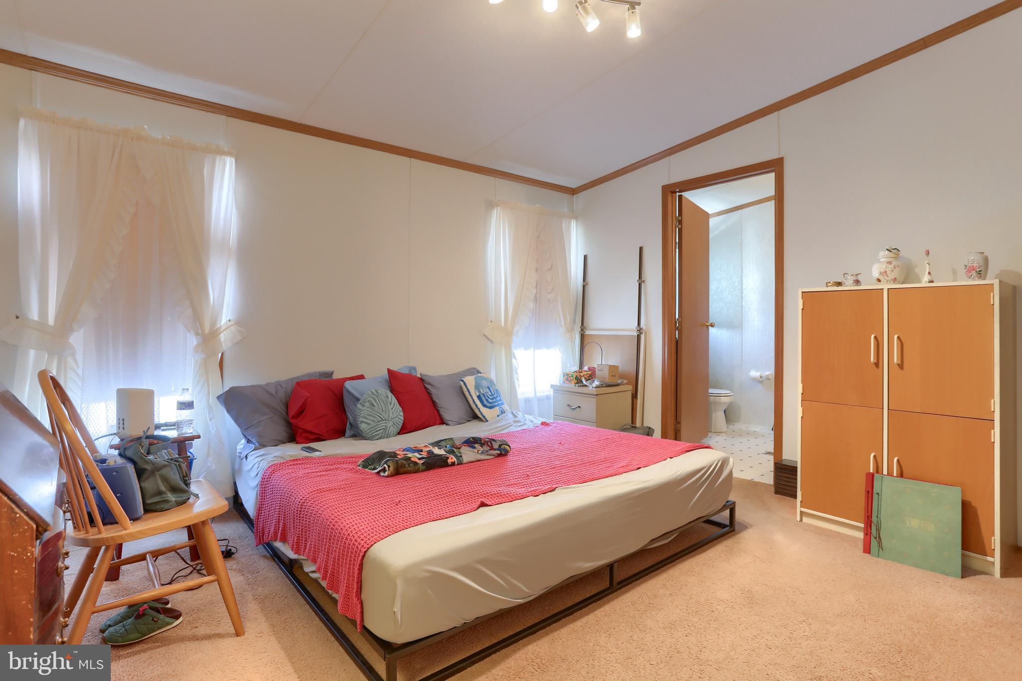 22 Elizabeth Avenue Lebanon, PA 17042 - Photo 17 of 28 a bedroom with a bed a lamp and a closet