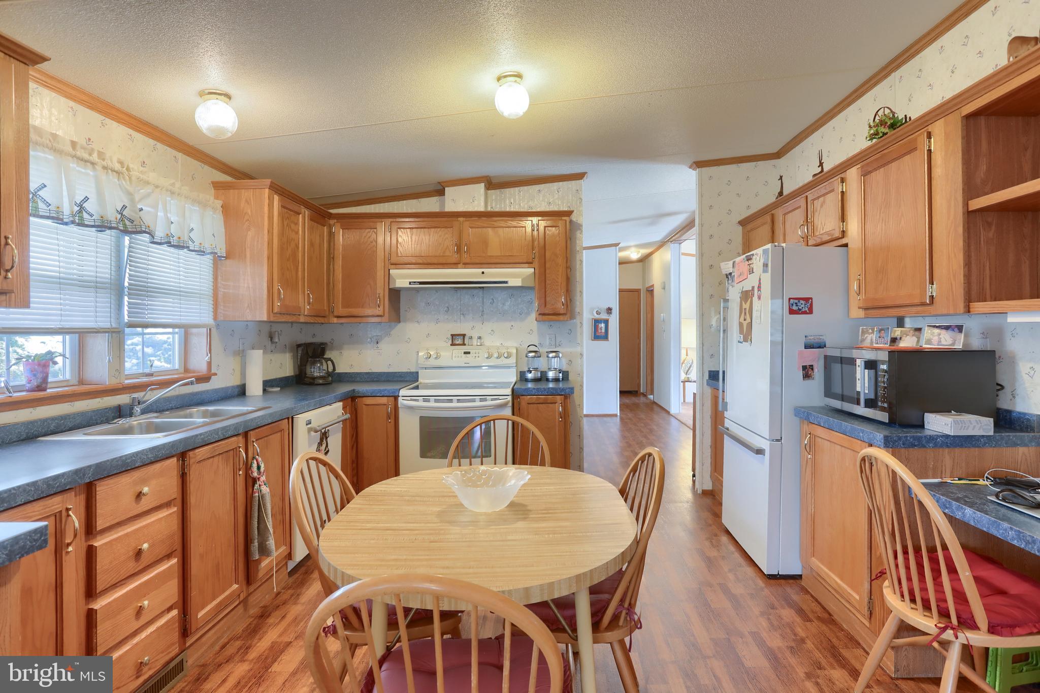 22 Elizabeth Avenue Lebanon, PA 17042 - Photo 9 of 28 a kitchen with stainless steel appliances granite countertop a refrigerator a sink a stove a dining table and chairs