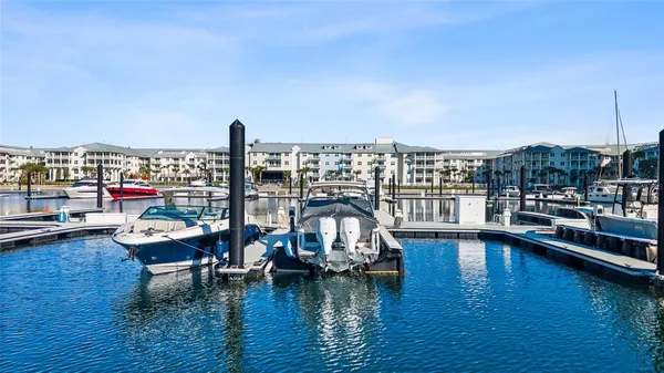 a view of a ocean with boats and trees in the background
