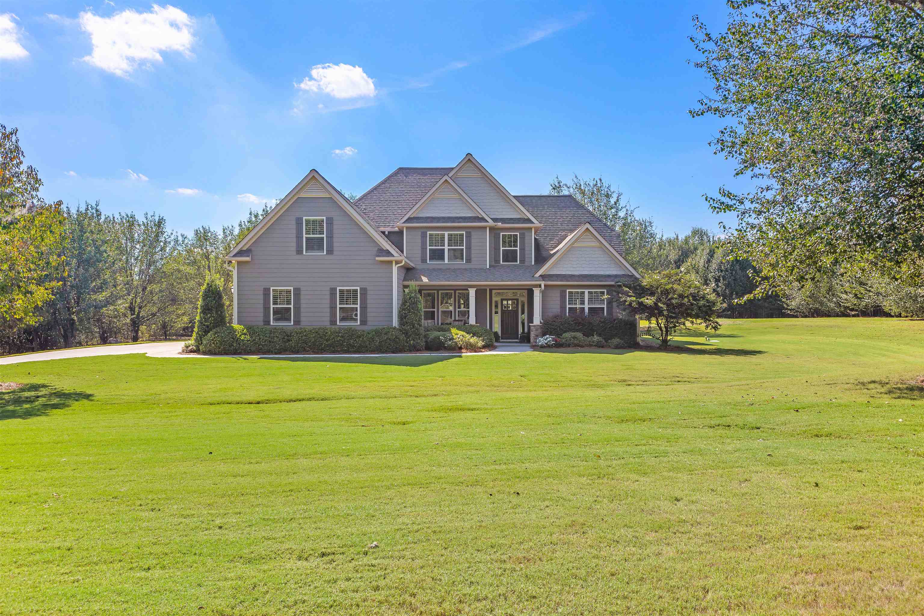 a front view of a house with a yard
