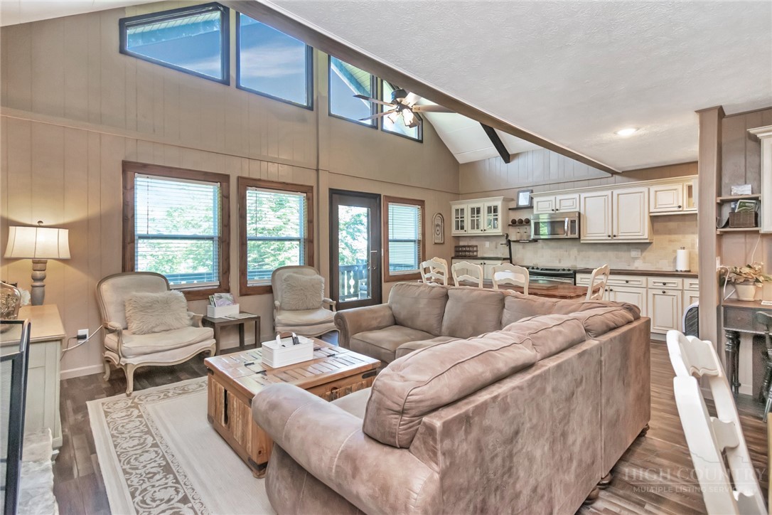 115 North Pinnacle Ridge Road, Unit 46 Beech Mountain, NC 28604 - Photo 17 of 42 a living room with furniture wooden floor and large windows