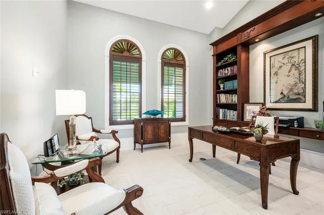 a living room with furniture a rug and white walls