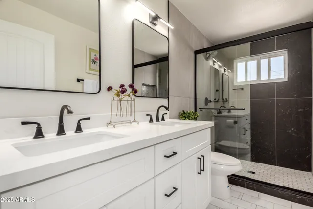 a bathroom with a double vanity sink mirror and double