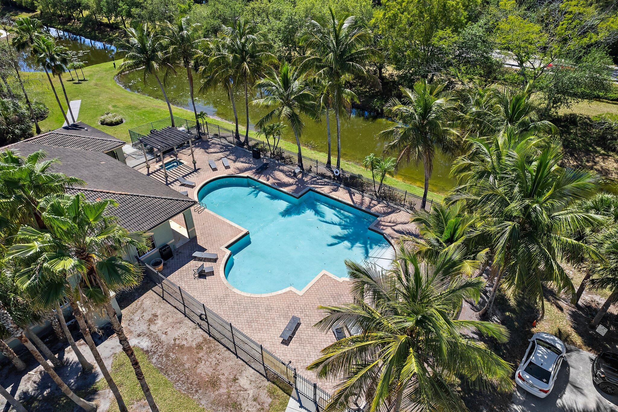 250 Crestwood Circle, Unit 208 Royal Palm Beach, FL 33411 - Photo 1 of 35 an aerial view of a swimming pool with lawn chairs and plants