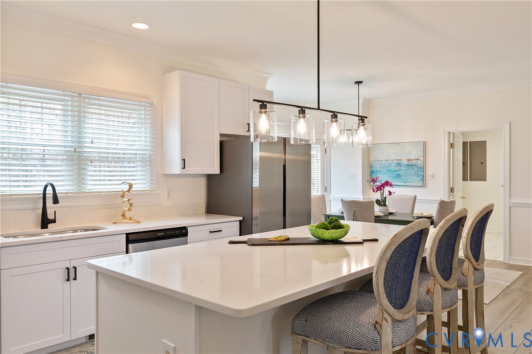 2130 Manakin Road Manakin-Sabot, VA 23103 - Photo 12 of 65 a kitchen with stainless steel appliances granite countertop a sink a stove a refrigerator a dining table and chairs