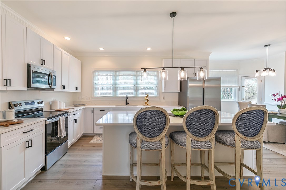 2130 Manakin Road Manakin-Sabot, VA 23103 - Photo 13 of 65 a kitchen with granite countertop a table chairs stove and cabinets