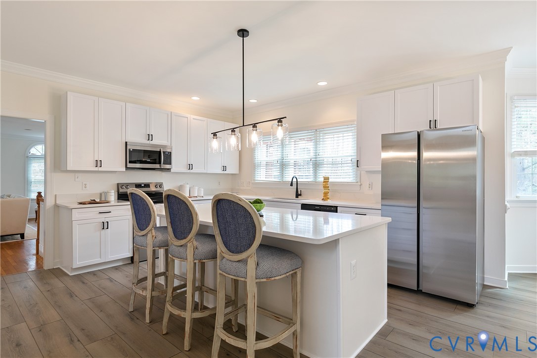 2130 Manakin Road Manakin-Sabot, VA 23103 - Photo 14 of 65 a kitchen with kitchen island granite countertop a center island stainless steel appliances cabinets and wooden floor