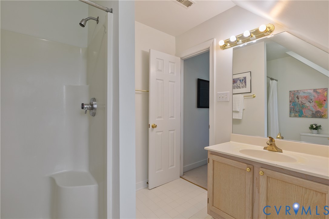 2130 Manakin Road Manakin-Sabot, VA 23103 - Photo 37 of 65 a bathroom with a double vanity sink a mirror and shower