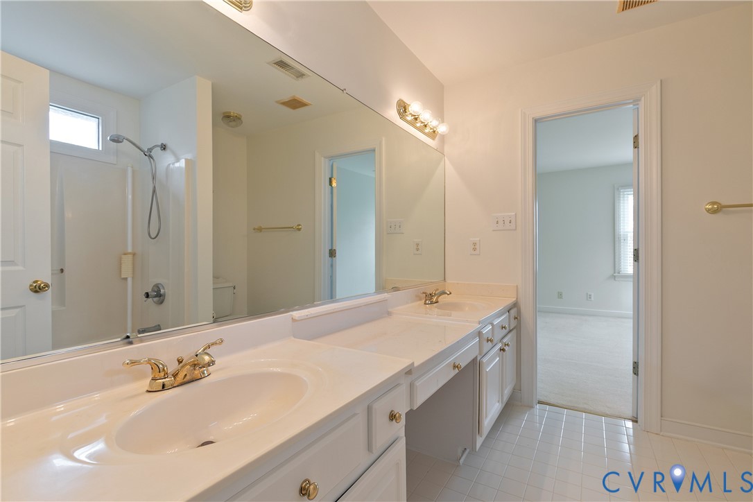 2130 Manakin Road Manakin-Sabot, VA 23103 - Photo 39 of 65 a bathroom with a sink double vanity and a mirror