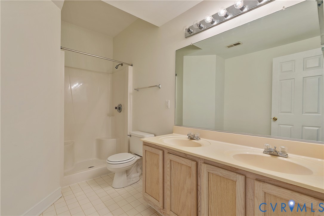 2130 Manakin Road Manakin-Sabot, VA 23103 - Photo 49 of 65 a spacious bathroom with a granite countertop sink a toilet and a mirror