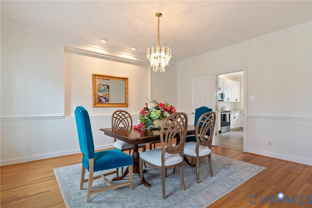 2130 Manakin Road Manakin-Sabot, VA 23103 - Photo 10 of 65 a dining room with furniture a chandelier and wooden floor