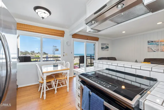 a kitchen with a stove and chairs
