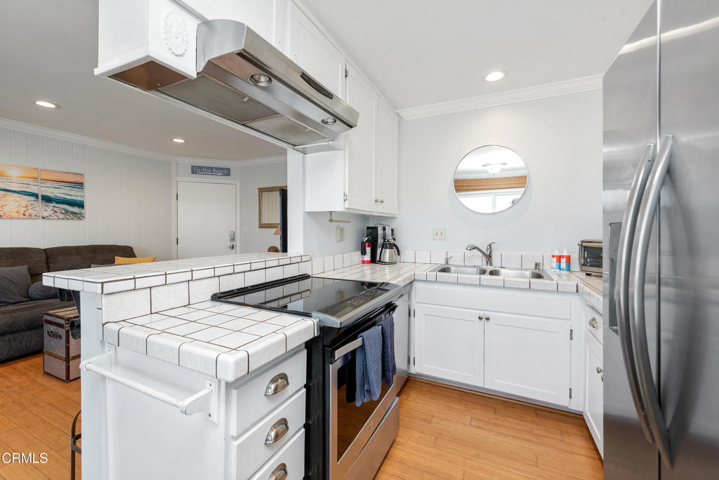 4975 Sandyland Road, Unit 302 Carpinteria, CA 93013 - Photo 10 of 28 a kitchen with a sink stove and refrigerator