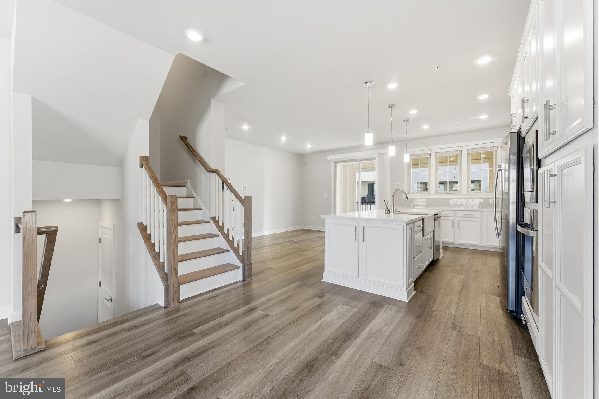 3754 Mayors Way Fairfax, VA 22030 - Photo 13 of 57 a white kitchen with wooden floor and electronic appliances