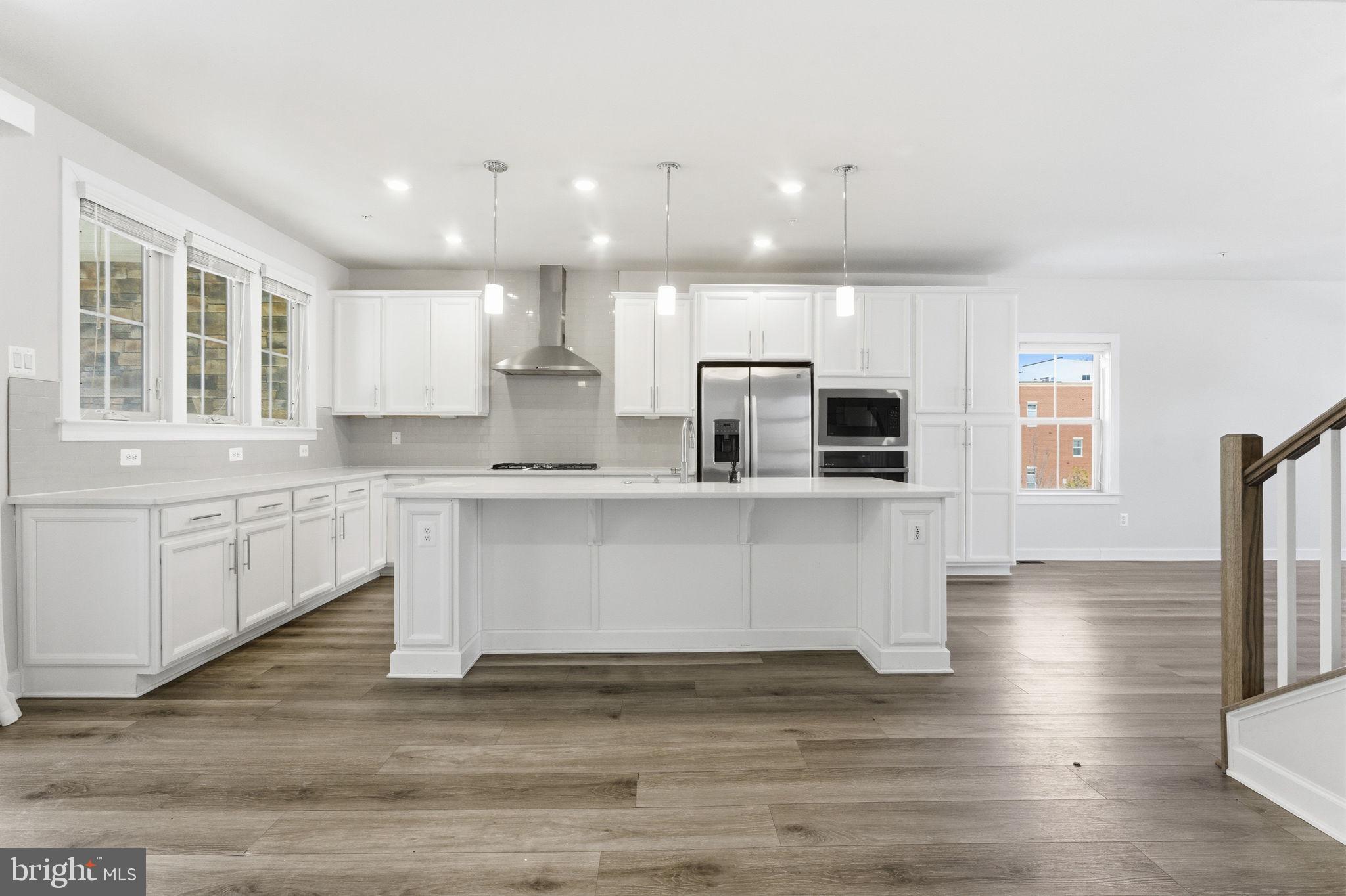 3754 Mayors Way Fairfax, VA 22030 - Photo 14 of 57 a view of kitchen with stainless steel appliances granite countertop a stove top oven a sink dishwasher a microwave oven and a refrigerator with wooden floor