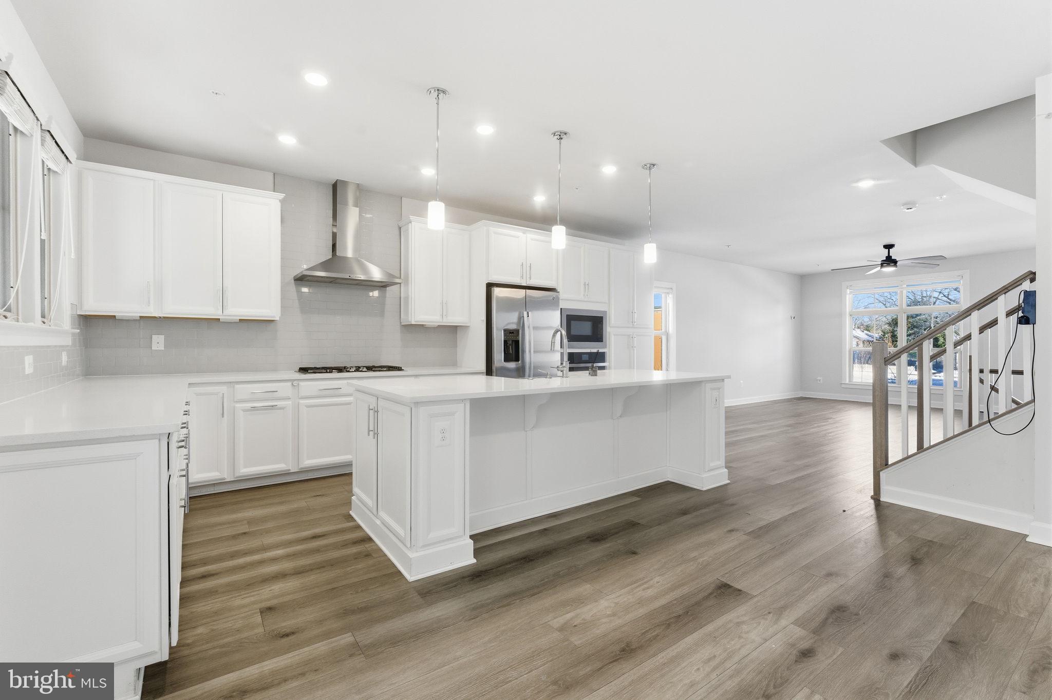 3754 Mayors Way Fairfax, VA 22030 - Photo 15 of 57 a large white kitchen with lots of white cabinets appliances and wooden floor