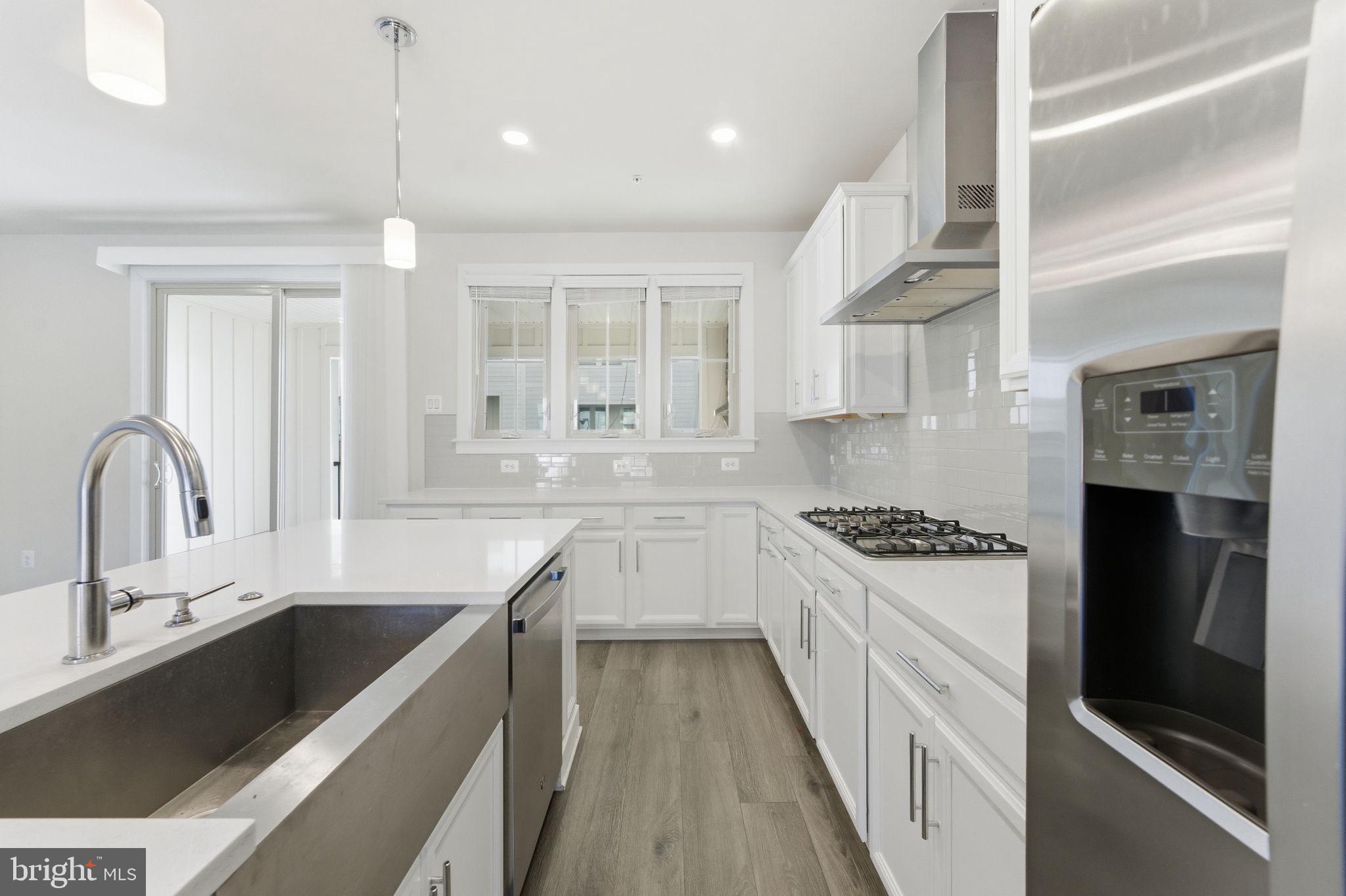 3754 Mayors Way Fairfax, VA 22030 - Photo 17 of 57 a kitchen with a sink a stove and cabinets
