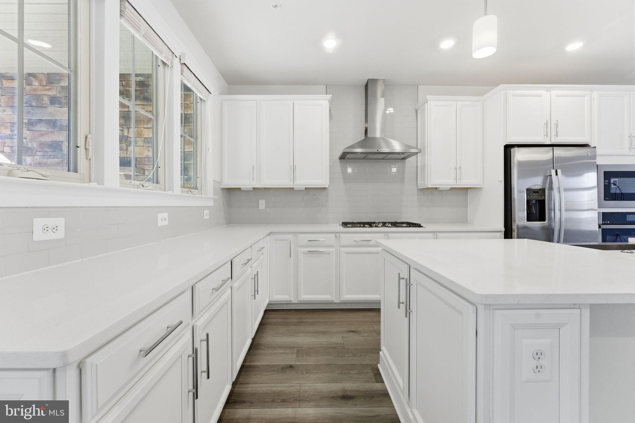 3754 Mayors Way Fairfax, VA 22030 - Photo 19 of 57 a kitchen with granite countertop white cabinets and white appliances