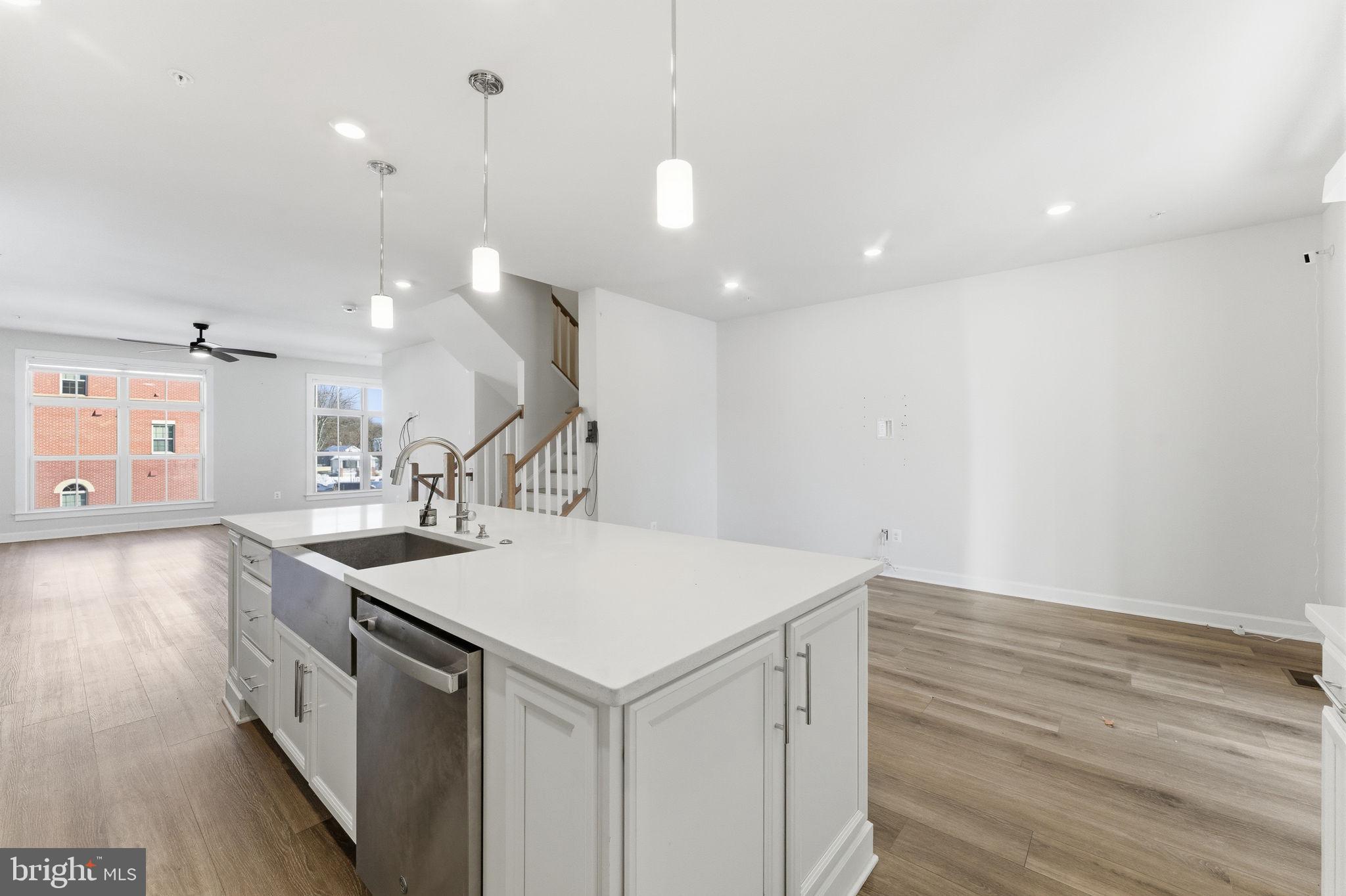 3754 Mayors Way Fairfax, VA 22030 - Photo 20 of 57 a kitchen with a stove a sink a center island and wooden floor